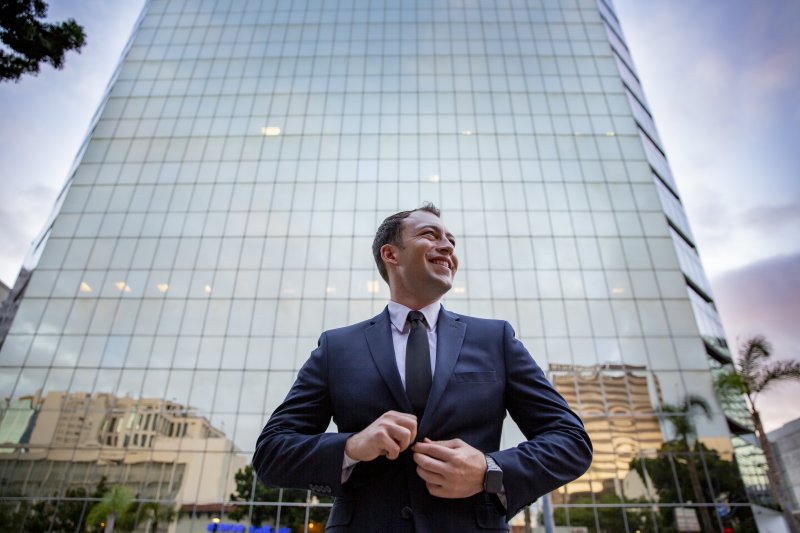 Businessman standing in front of glass building