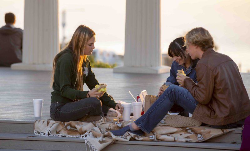 Students eat burritos on campus