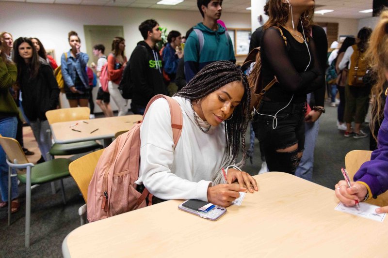 A student writes a check