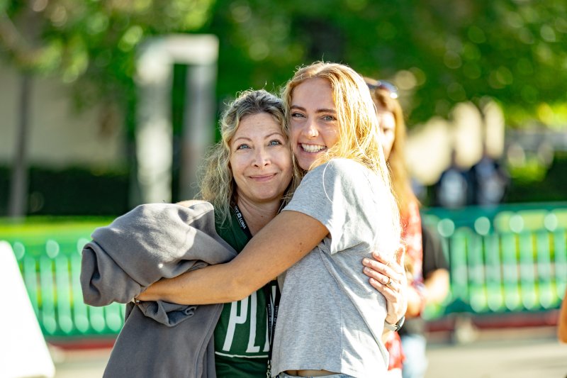 Smiling PLNU student hugging her mom