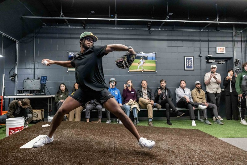 PLNU pitcher steps to throw a pitch at the Biomechanics Lab
