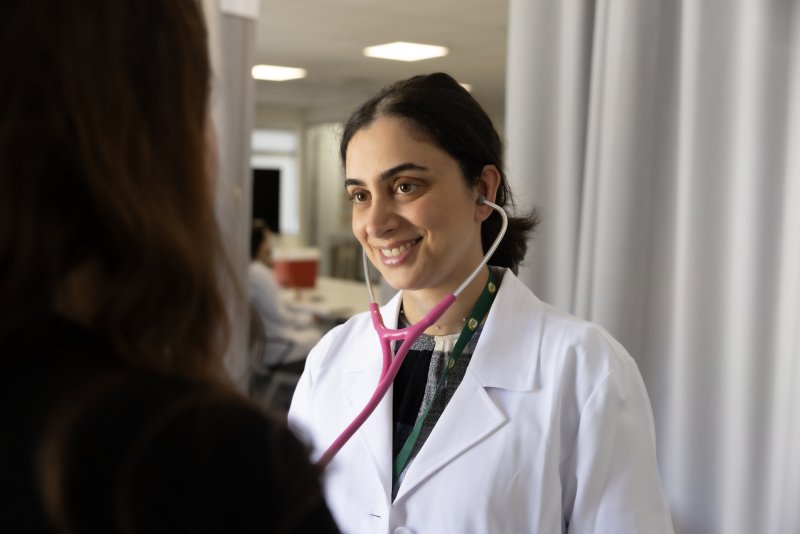 PLNU nursing student performs health examination on volunteer at university's Balboa Campus nursing lab.