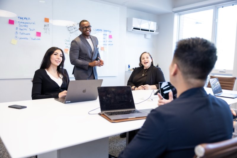 business students in a classroom talking about a project 