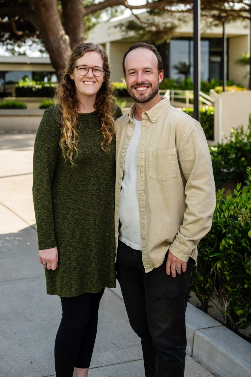 Sarah and Nate Hamill pose together in front of Fermanian School of Business. 