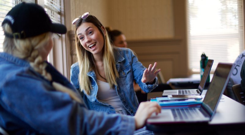 Girls in class chatting