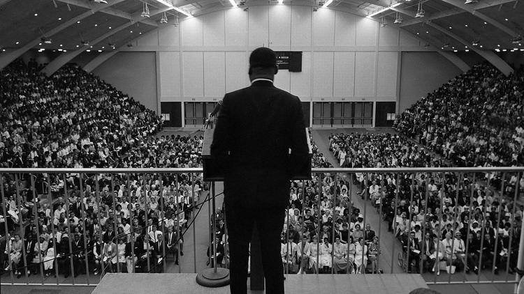 Martin Luther King Jr speaks to a large crowd gathered in Golden Gymnasium.