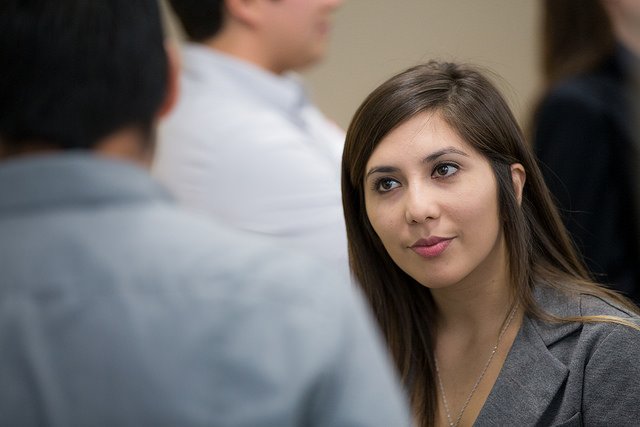 Female student in crowd having a conversation