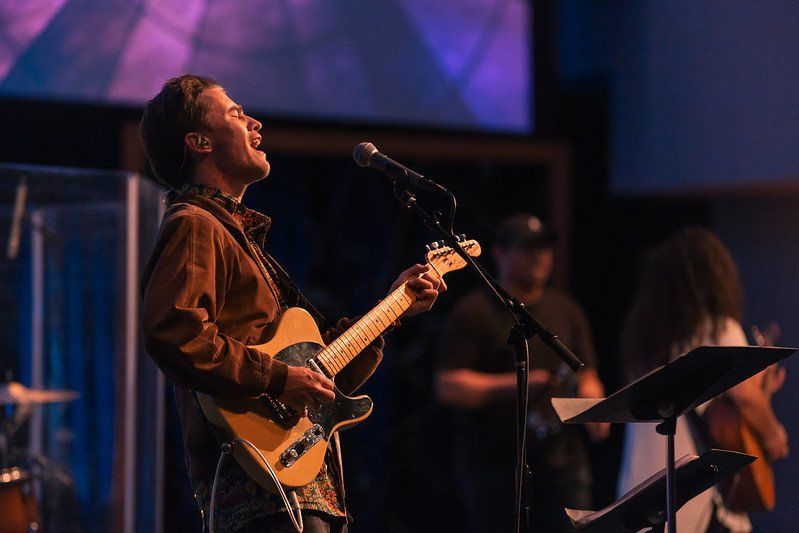 A musician playing the guitar at a PLNU Chapel service