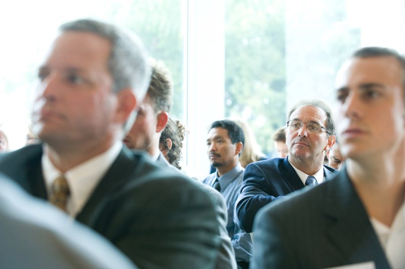 Men in business suits at a Dealmakers Breakfast hosted by PLNU