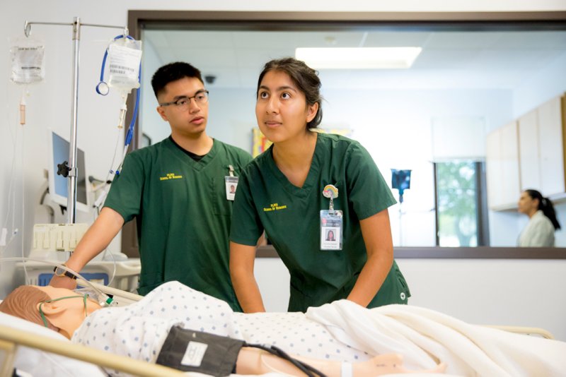 Two nursing students practicing their skills.