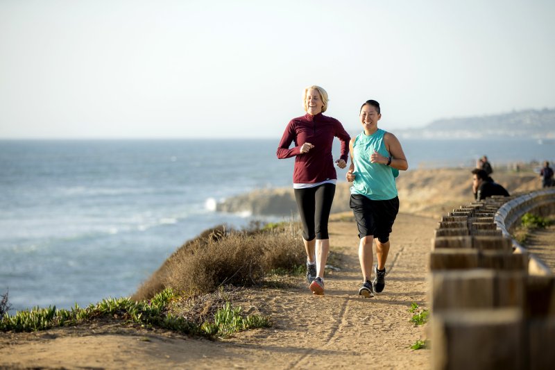 Integrative wellness students run the cliffs below PLNU