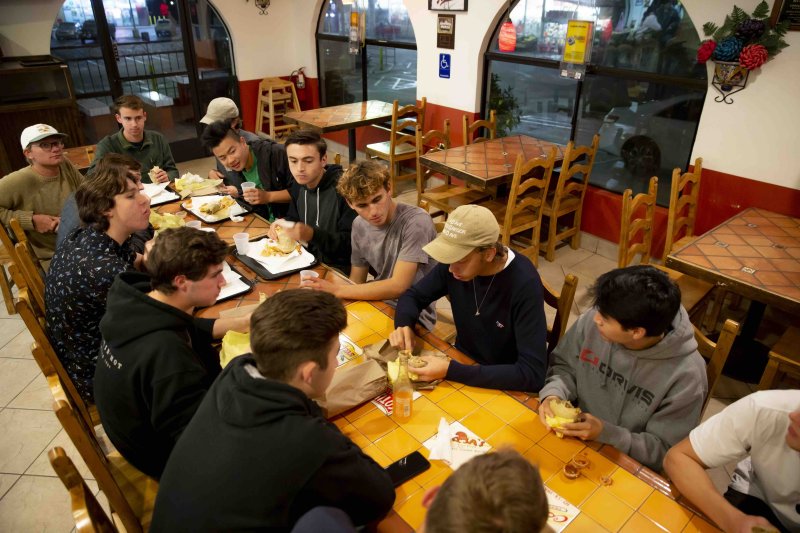 Friends eat burritos at a restaurant