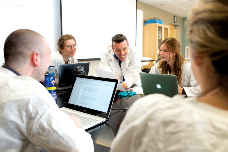 Undergraduate Biology students with professor during class