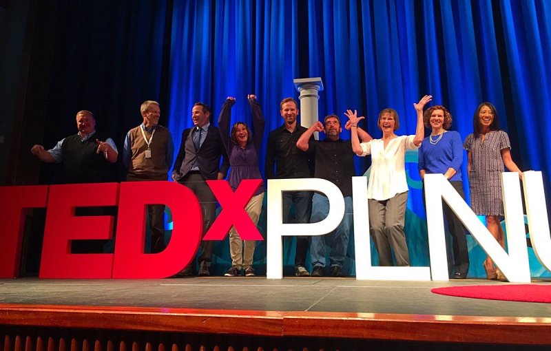 PLNU TEDx speakers stand on stage in celebration