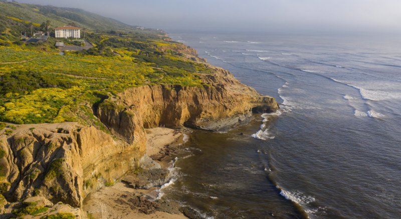 Aerial view overlooking Young Hall with the rugged coastline off the campus of PLNU