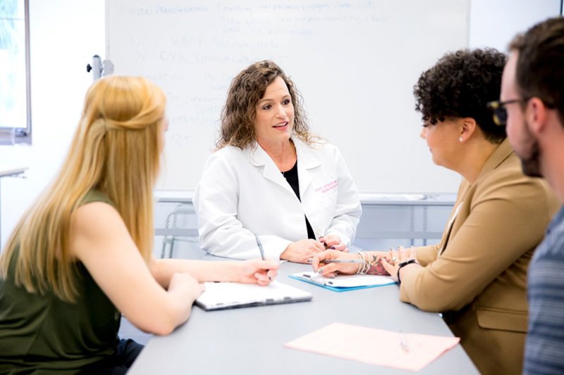 A nurse talking to students about the 4 advanced practice (APRN) careers in nursing. 