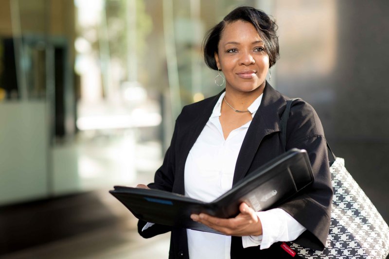 woman opening a binder and looking into the distance 