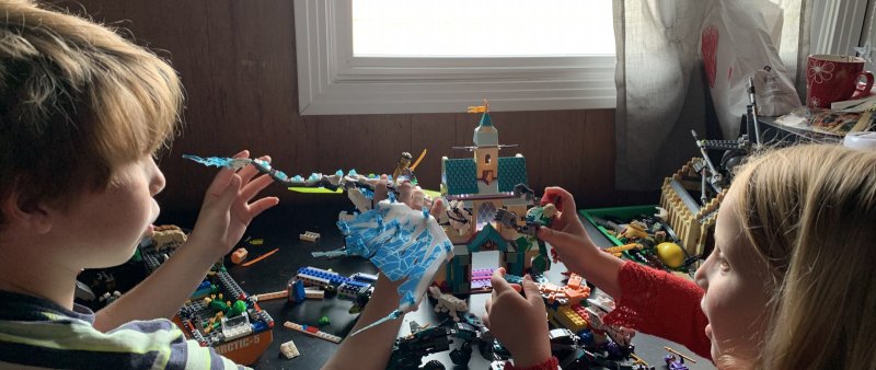 Two children pictured playing with Lego. 