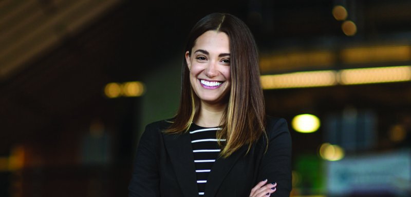 An MBA student confidently smiles while at a photoshoot in downtown San Diego