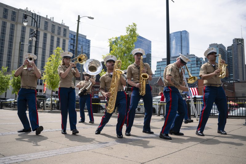 7 musicians playing various brass instruments with movement