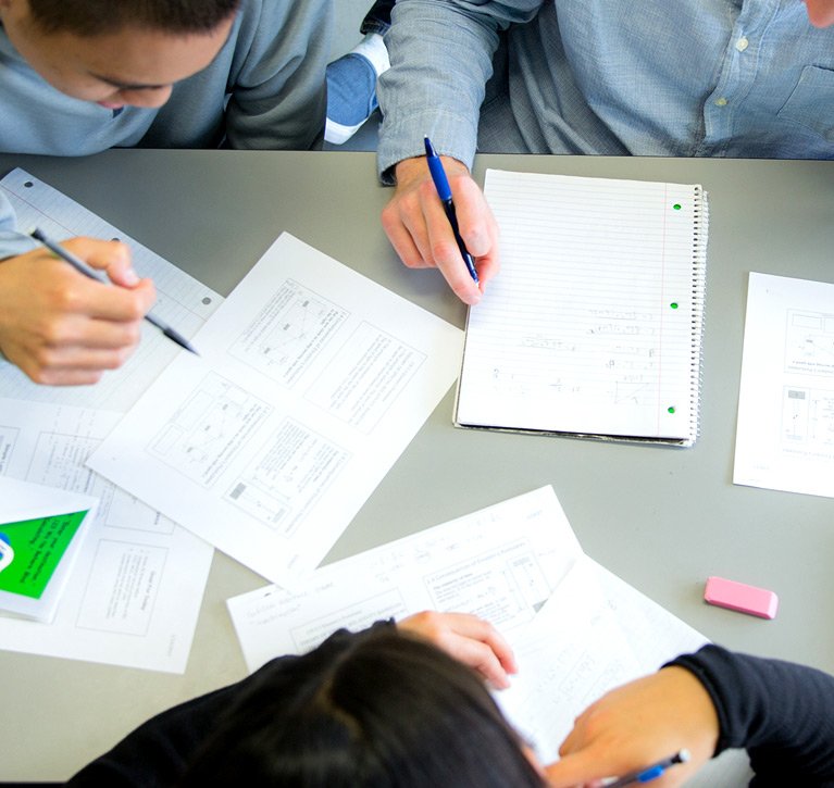 A group of students work on their assignment in class.