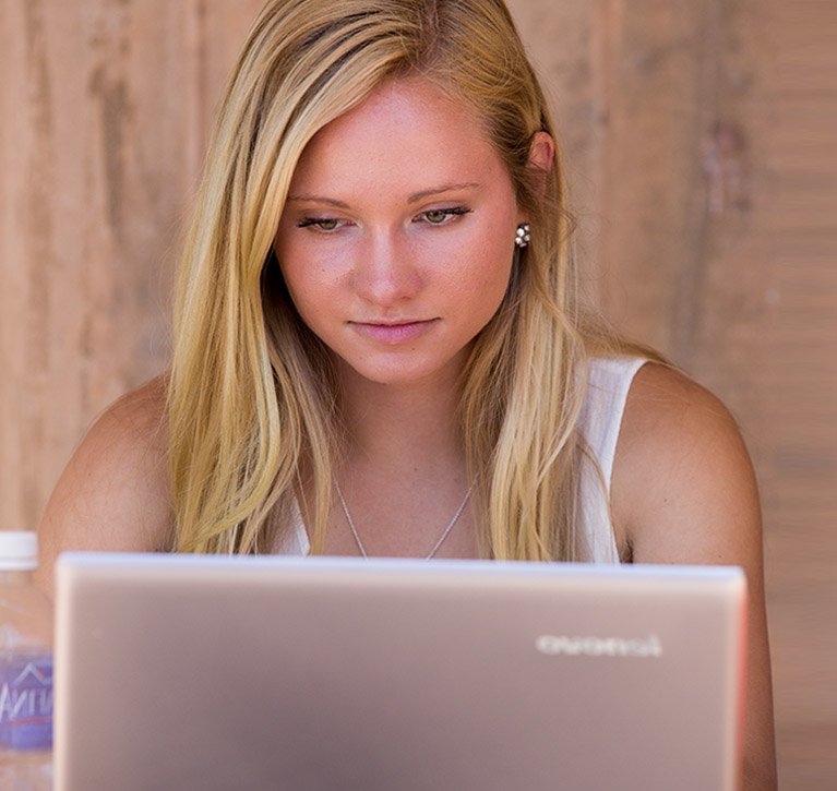 A student works on her laptop