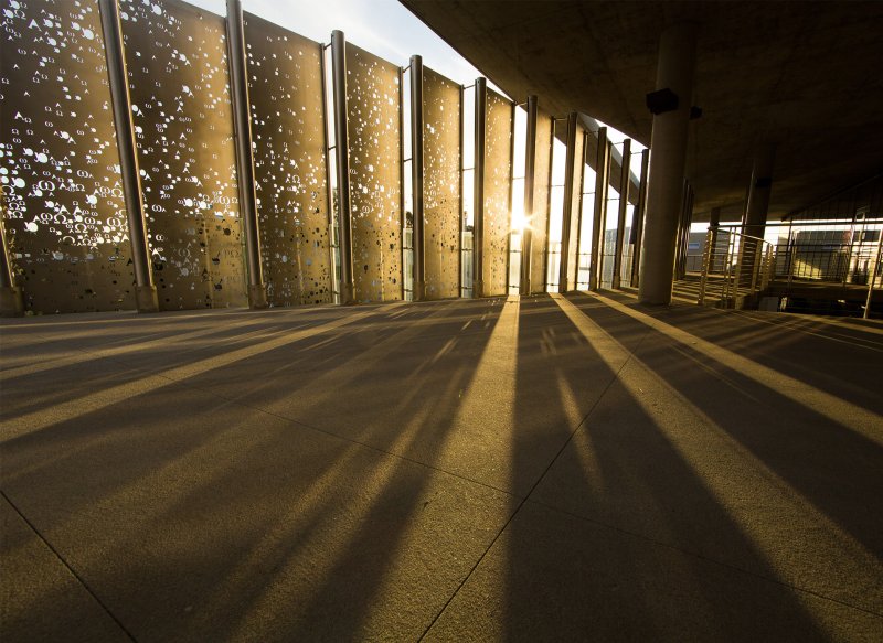 Sunset through the Alpha and Omega metal screen at Sator Hall