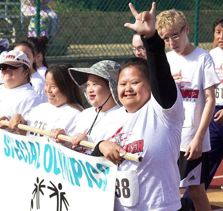 Athletes march in the opening ceremony of the Special Olympics at the PLNU track and field in San Diego