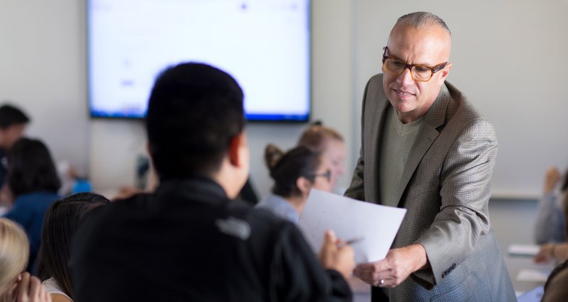 Professor Kim Schaefer helps student during class