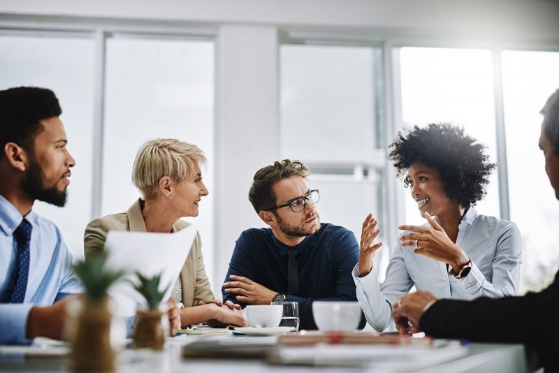 A group of workplace professionals have an informal meeting