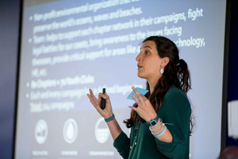 teacher talking in front of a power point slide