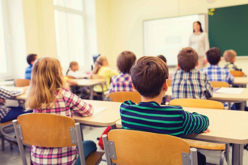 Children sit in a classroom during instruction