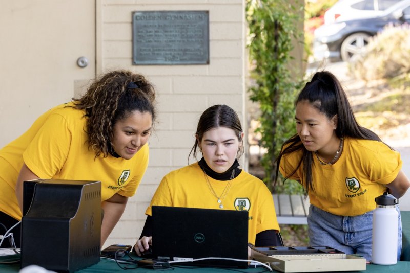 Student workers working the ticket booth before a PLNU sports game.