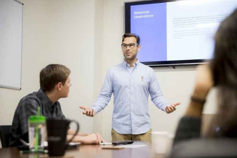 teacher speaking in front of students