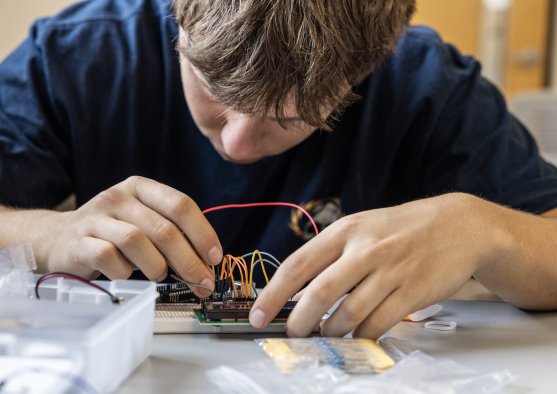 PLNU engineering student assembles and tests an electronic circuit on a breadboard.