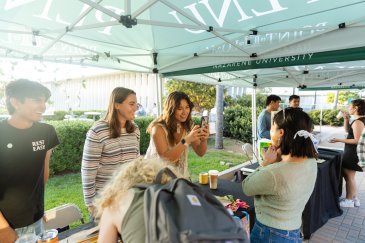 PLNU students and club members chatting. 
