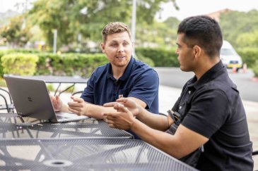 Two PLNU military students work outside together. 