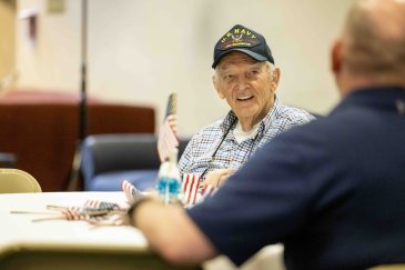 Military veteran connects with table mate at Warrior Breakfast.