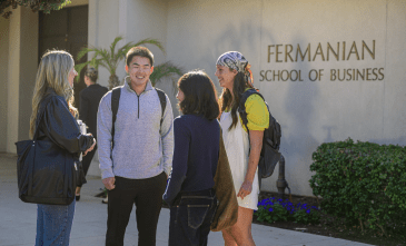 FSB students stand outside the building and chat
