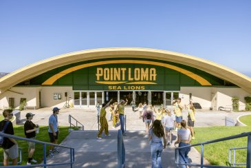 Golden Gymnasium with students walking in front