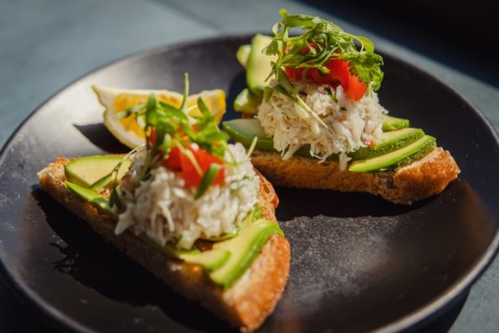 Avocado toast with crab and tomato topping from Mitch's Seafood San Diego